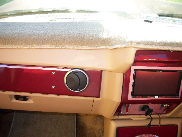 Dashboard with aftermarket stereo and red trim