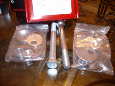 2004 Ford Crown Victoria - Suspension components are laid out on a table, including bolts and washers in packaging.