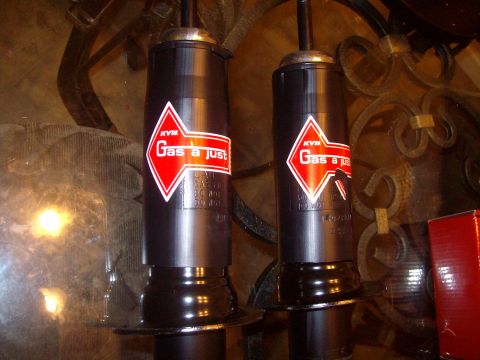 2004 Ford Crown Victoria - Close-up of two KYB Gas-a-just shock absorbers, likely for sale or recently purchased.