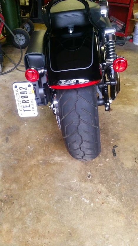 2014 Harley-Davidson FXDWGI Wide Glide - The rear fender, taillight, and license plate of a black motorcycle are visible.