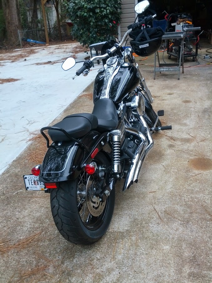 Black Harley-Davidson motorcycle parked on concrete. License plate reads TERB92