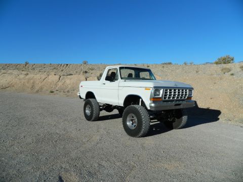 1979 Ford Bronco - This lifted 1978 Ford Bronco is parked in a desert area under a clear blue sky.