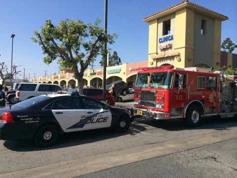 1968 Ford Mustang - Emergency vehicles, a police car and a fire truck, are at a scene in front of a commercial building.