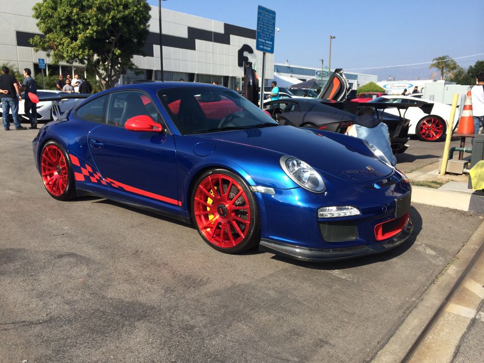 Blue Porsche 911 with red wheels and racing stripes