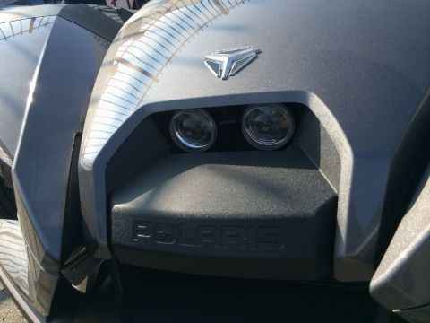 1968 Ford Mustang - The front of a three-wheeled Polaris vehicle is shown, its distinctive headlights and brand name.