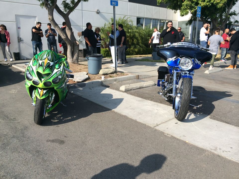Green sportbike and blue cruiser motorcycle parked outside