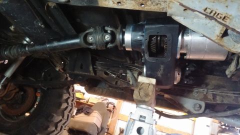 1995 Ford Bronco - Close-up view of the transfer case and driveshaft assembly of a vehicle.