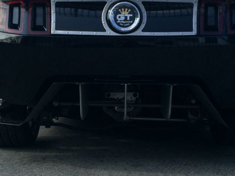 1968 Ford Mustang - Close-up of a car's rear end, showing the GT emblem and exhaust system.