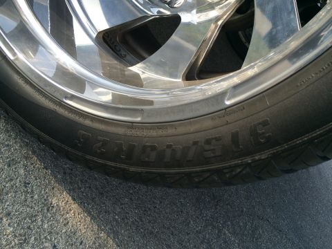 1968 Ford Mustang - A close-up view of a vehicle's tire and custom chrome rim, showing tire size information.