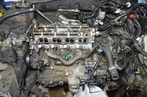 2007 Mazda 6 - Engine bay with engine partially disassembled, showing internal components and wiring.