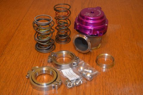 2007 Mazda 6 - A collection of performance automotive parts, including a blow-off valve and various springs, are laid out on a wooden surface.