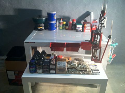 1992 Ford Mustang - A workbench is set up with various reloading supplies, including a press, ammunition, and canisters.
