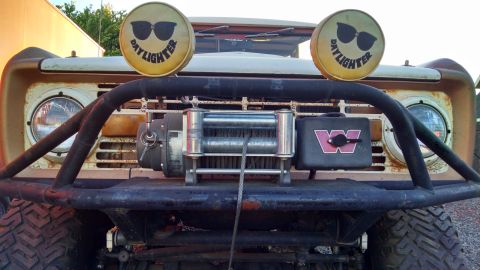 1985 Jeep CJ7 - Front view of a weathered Jeep CJ-series, equipped with a winch and auxiliary lights.