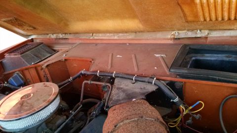 1985 Jeep CJ7 - Close-up view of an engine bay with visible wiring and air intake components.