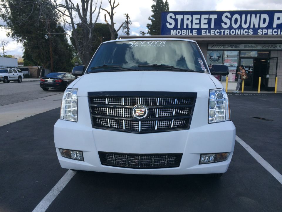 White Cadillac Escalade front view with chrome grille and headlights
