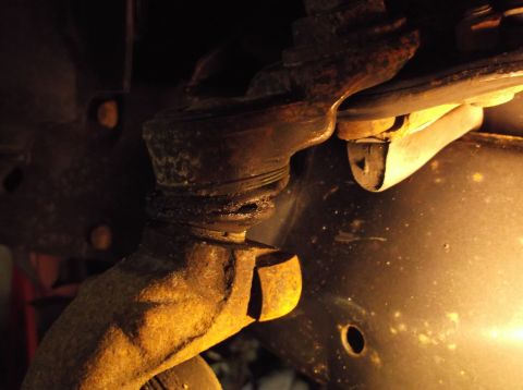 1999 Mercury Grand Marquis - Close-up view of worn ball joint and suspension components, likely requiring front-end rebuild.