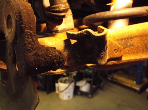 1999 Mercury Grand Marquis - Close-up view of a rusty suspension part, likely from a vehicle's front end.