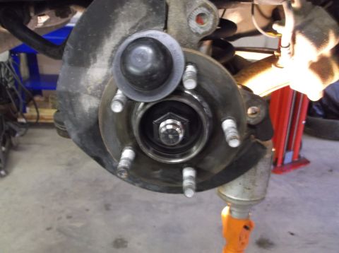 1999 Mercury Grand Marquis - Close-up of a vehicle's wheel hub assembly, showing the brake rotor and lug studs.