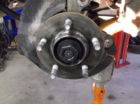 1999 Mercury Grand Marquis - Front wheel hub assembly with brake rotor and lug studs visible.