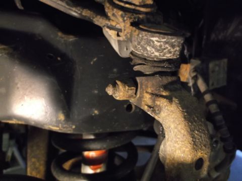 1999 Mercury Grand Marquis - Detail of a corroded suspension part, likely from a front-end rebuild project, with a Supermotors watermark.