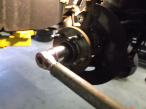 1999 Mercury Grand Marquis - Close-up view of a vehicle's front suspension system, possibly undergoing repair.