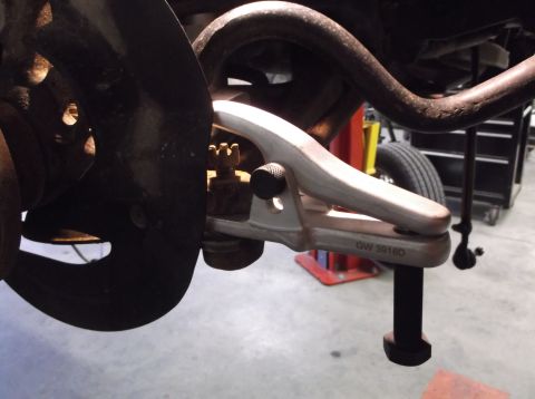 1999 Mercury Grand Marquis - Ball joint separator tool is used on a vehicle's suspension system.