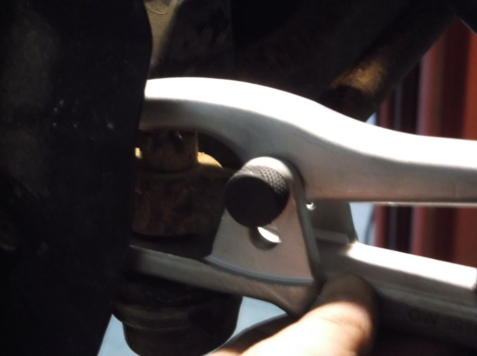 Close-up of a wrench on a rusty suspension ball joint