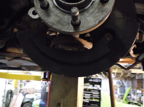 1999 Mercury Grand Marquis - Vehicle brake rotor and dust shield detail, possibly during a front-end rebuild.