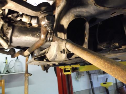 1999 Mercury Grand Marquis - Close-up view of a vehicle's undercarriage, highlighting suspension and exhaust system components.