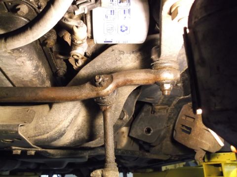 1999 Mercury Grand Marquis - Close-up view of suspension parts, including an oil filter, likely from a vehicle undergoing maintenance.