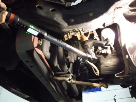 1999 Mercury Grand Marquis - A torque wrench is used on the undercarriage of a vehicle during a front-end rebuild.