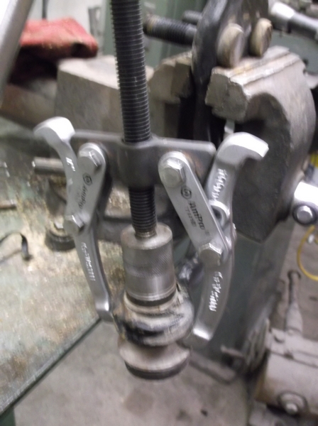 1999 Mercury Grand Marquis - A bearing puller tool is secured in a vise, ready for use in a mechanical repair.