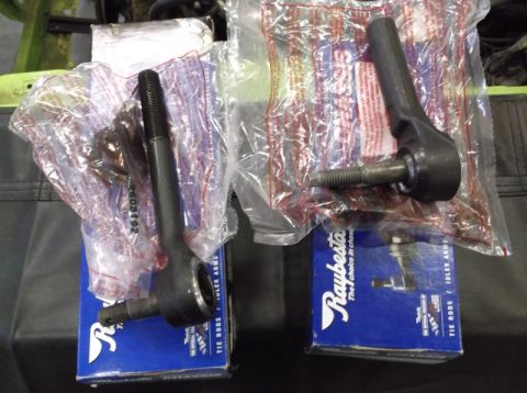 1999 Mercury Grand Marquis - Two new Raybesto tie rod ends are shown, packaged for sale and sitting on their respective blue product boxes.