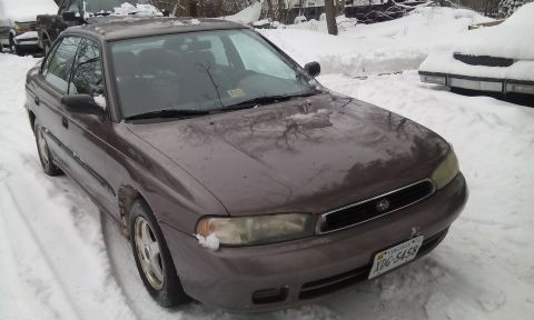 1996 Subaru Legacy - This 1996 Subaru Legacy sedan is parked outside in a snowy environment.