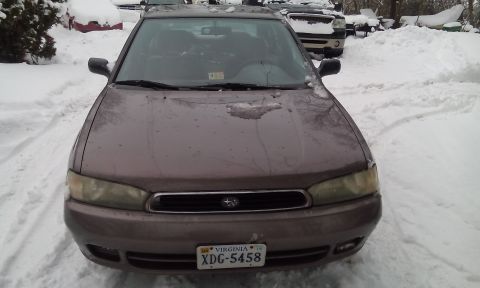 1996 Subaru Legacy - A 1996 Subaru Legacy is parked in the snow, with another vehicle visible in the background.