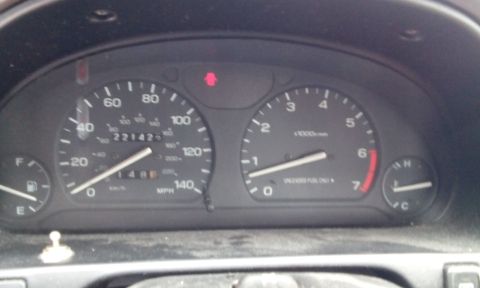 1996 Subaru Legacy - Interior view of a car's dashboard, showing the speedometer and tachometer with an odometer reading of 221423.