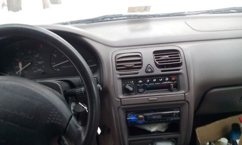 1996 Subaru Legacy - The interior dashboard of a 1996 Subaru Legacy, an aftermarket stereo system.