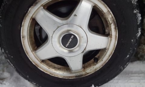 1996 Subaru Legacy - Subaru wheel and tire shown in detail, with visible brake rotor behind the wheel.