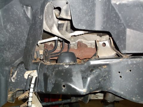 1999 Mercury Grand Marquis - Close-up of vehicle frame and engine parts, likely during a repair or inspection.