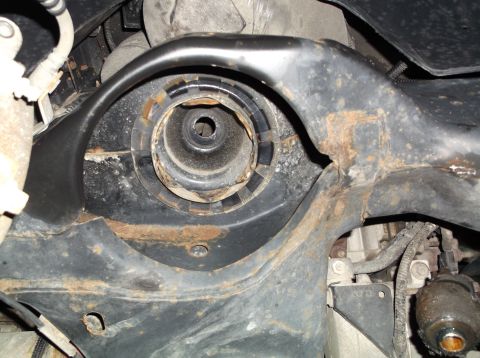 1999 Mercury Grand Marquis - Close-up view of a worn suspension part, showing rust and damage.