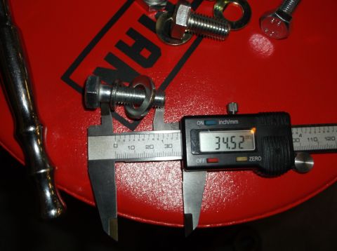 1999 Mercury Grand Marquis - A bolt and washer are measured with a digital caliper, showing a reading of 34.52mm.