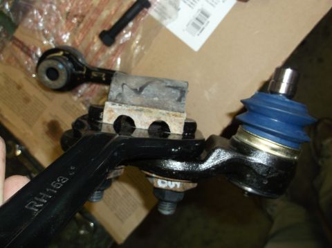 1999 Mercury Grand Marquis - Suspension ball joint assembly with part number RH153 visible on the metal arm.