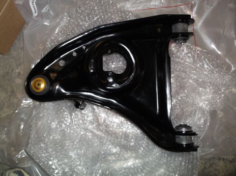 1999 Mercury Grand Marquis - A black control arm, likely a replacement part, is shown in its packaging.