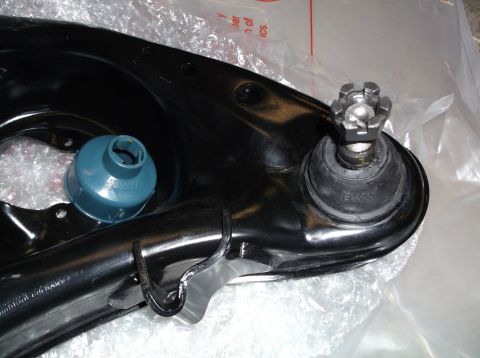 1999 Mercury Grand Marquis - A close-up view of a vehicle's suspension part, a ball joint with a control arm, is shown.