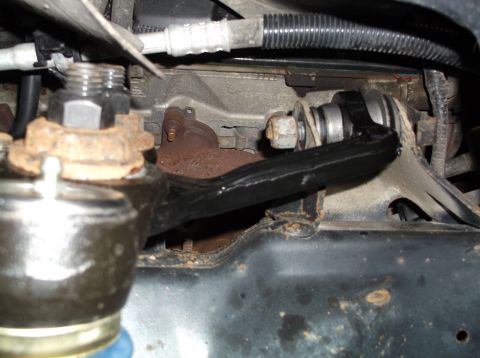 1999 Mercury Grand Marquis - Detail of a vehicle's undercarriage, focusing on a suspension part during a front-end rebuild.