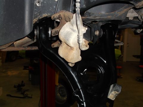 1999 Mercury Grand Marquis - The photo shows a close-up view of a vehicle's brake caliper and suspension system, likely during maintenance.