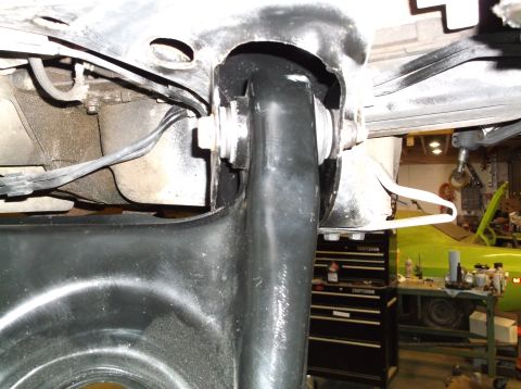 1999 Mercury Grand Marquis - Close-up of a vehicle's suspension system, showing a black arm and mounting hardware.