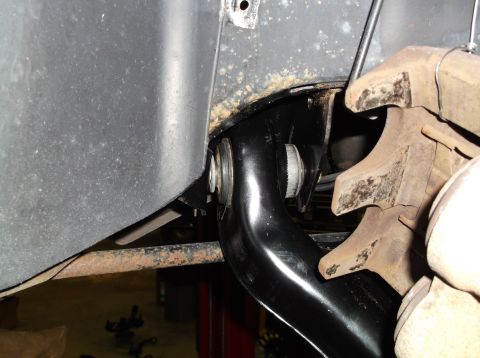 1999 Mercury Grand Marquis - This image shows a close-up view of a vehicle's suspension system, focusing on a suspension arm and brake components.