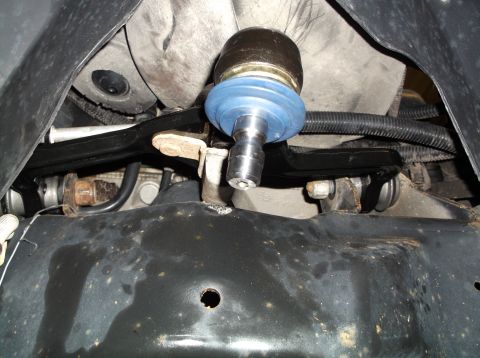 1999 Mercury Grand Marquis - Close-up view of a vehicle's suspension system, focusing on a ball joint.