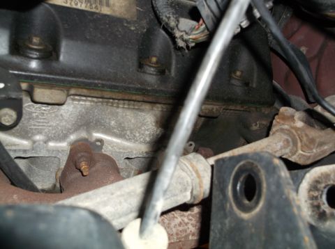 1999 Mercury Grand Marquis - Close-up view of an engine exhaust manifold, showing a Ford logo stamped into the metal.